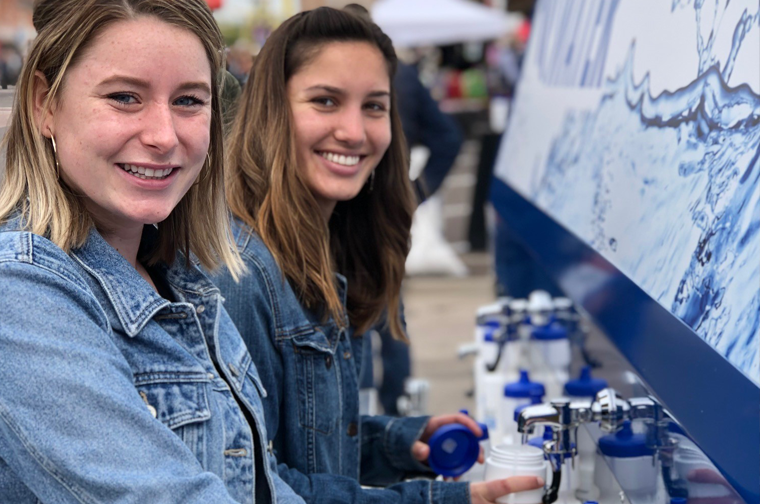two young ladies filling up water bottles from the scottsdale water truck