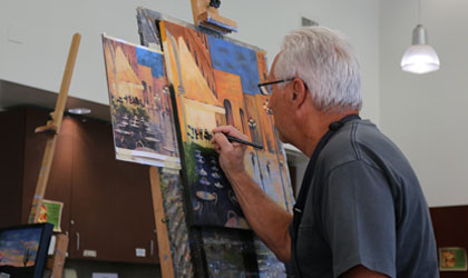 artist painting on an easel