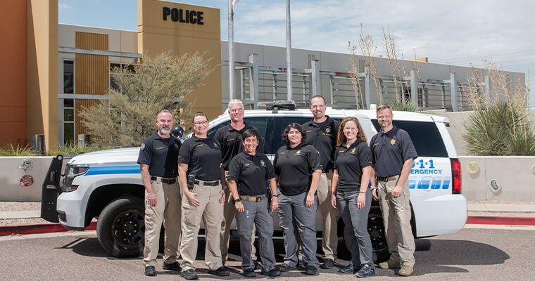 the crime prevention team posing together in front of the police station