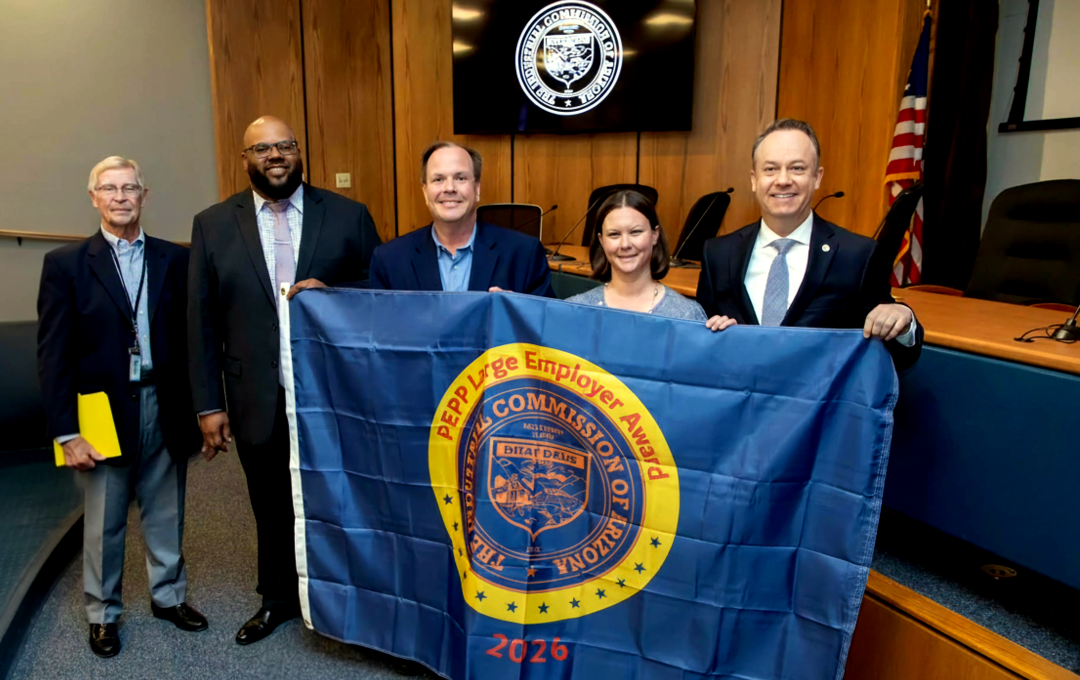 A group of five people hold a blue "PEPP Large Employer Award 2026" flag for Arizona.