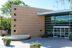 Granite Reef Senior Center entrance with brick exterior, glass doors, and small circular fountain.