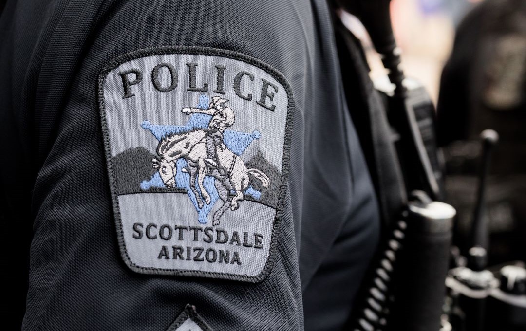 Close-up of a Scottsdale Police uniform sleeve showing the department patch.