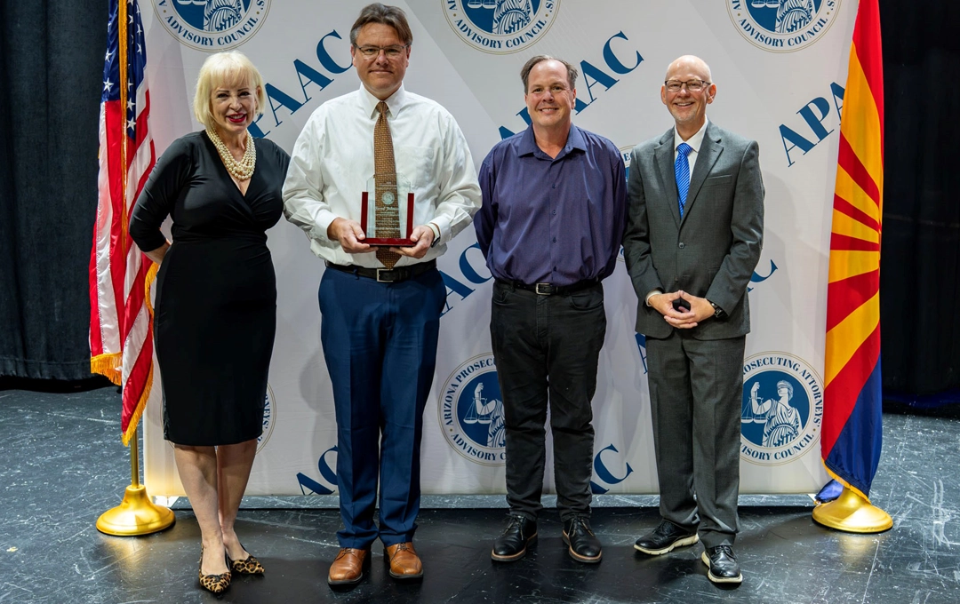 Group of people showing an award