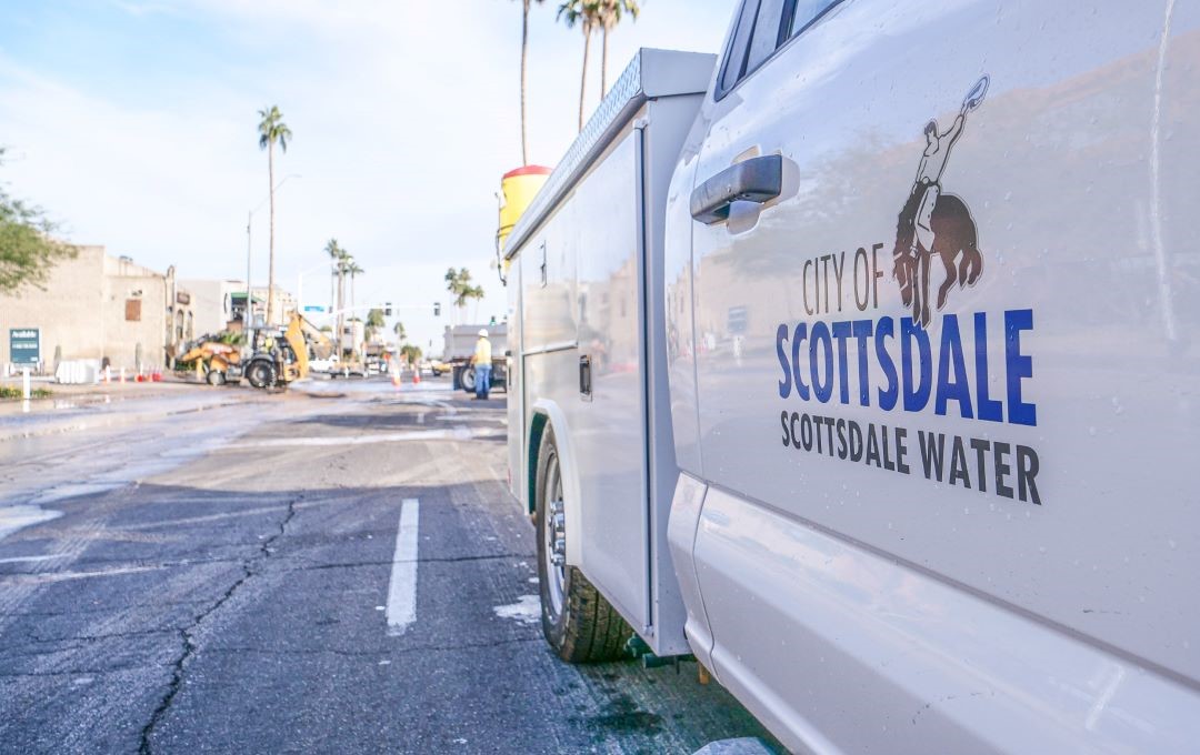 A City of Scottsdale Water truck parked on a street near a construction zone.