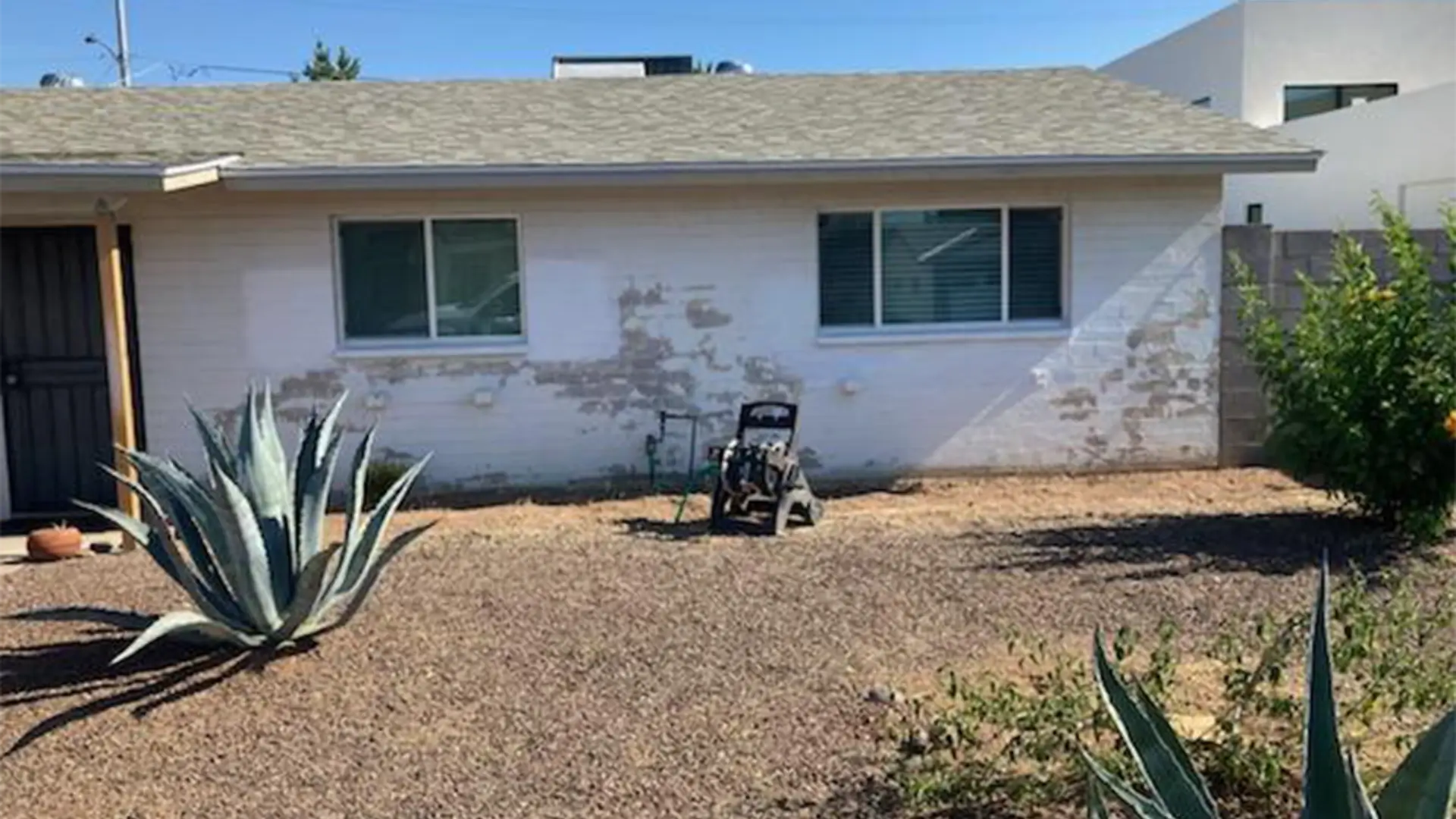 House with old white paint peeling off.